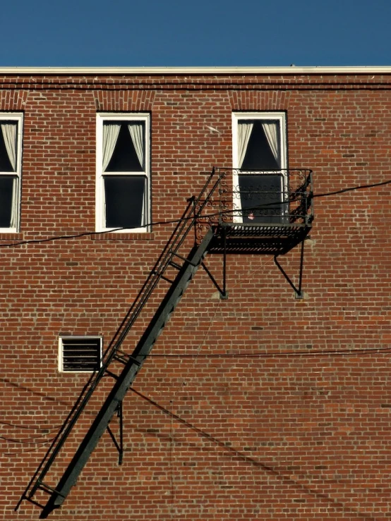 a red brick building with a staircase going up it