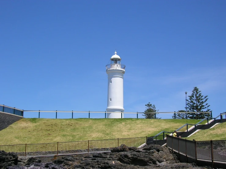 a lighthouse on the side of a hill