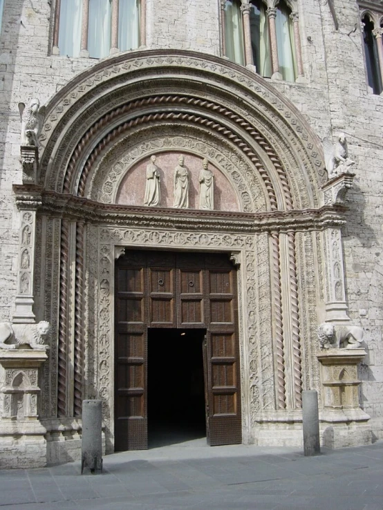 an entrance to a very ornate stone church