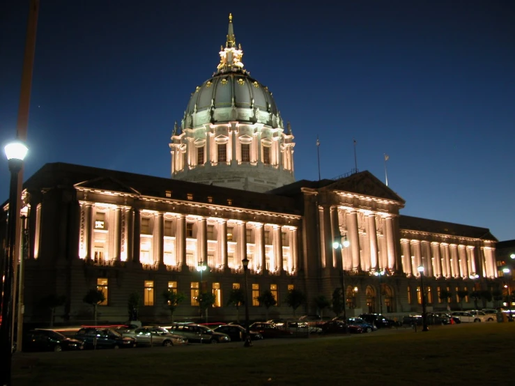 a large government building is lit up at night
