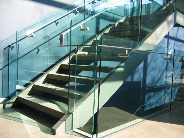 the stairs of an open glass door leading up to a stairway