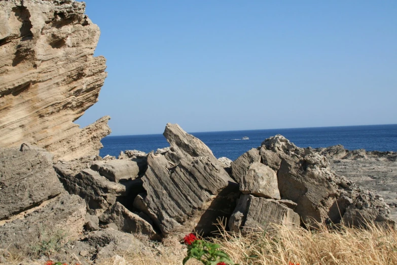 several large rocks near the water with one in between