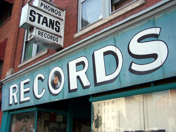a record store that has some signs on it