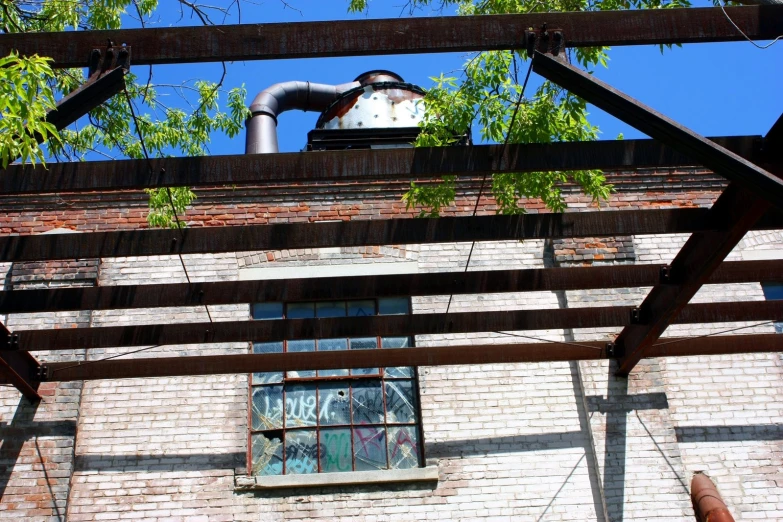 a factory with windows in the middle of an overpass