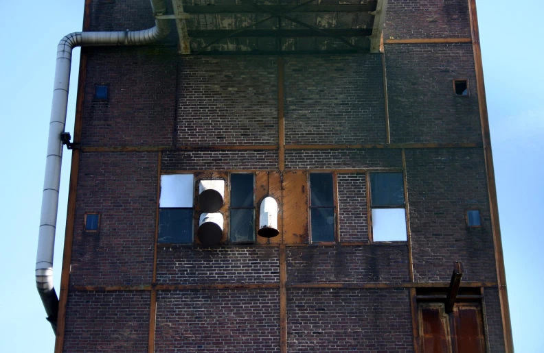 looking up at a very tall building with some windows