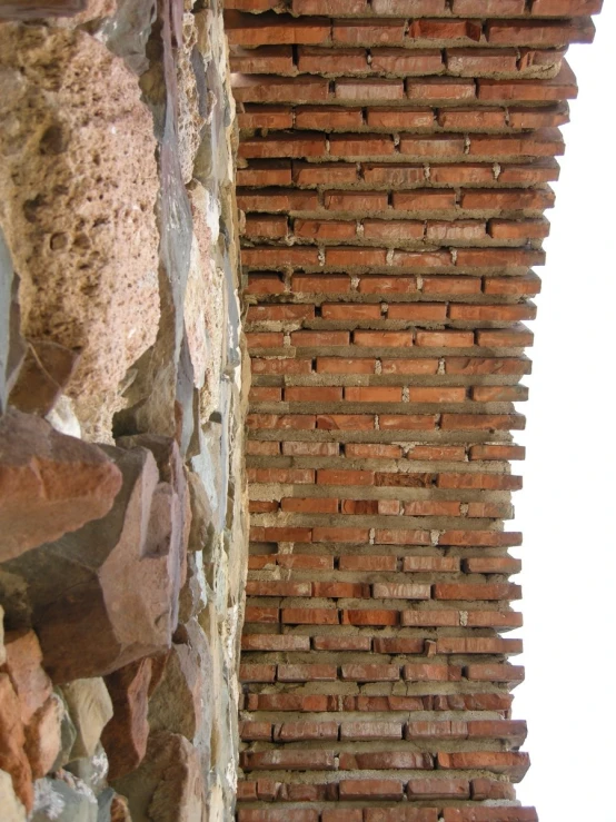 a wall made of bricks and stones, looking up