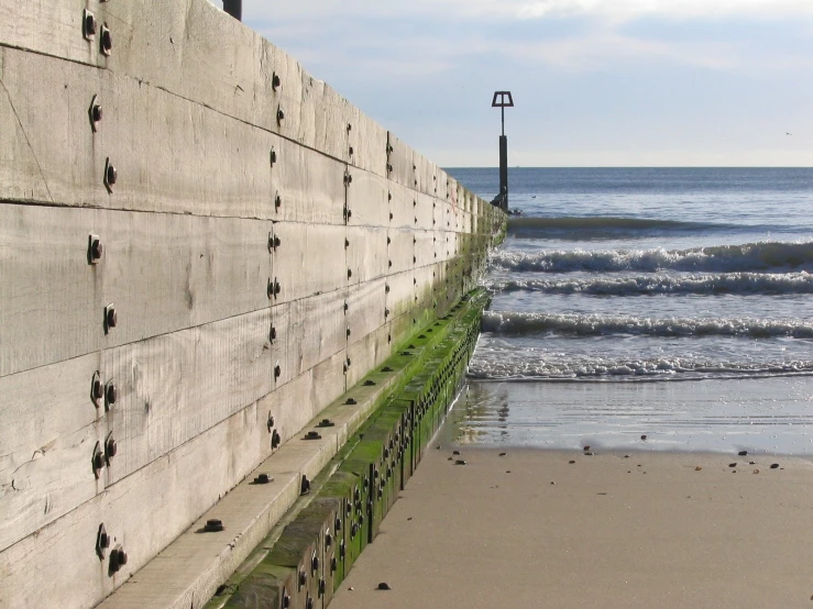 a section of the shoreline wall next to a beach