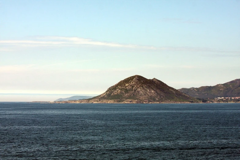 a body of water with a small island in the distance