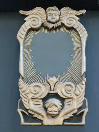 an artistic wooden plaque featuring a cherub and double - headed angel