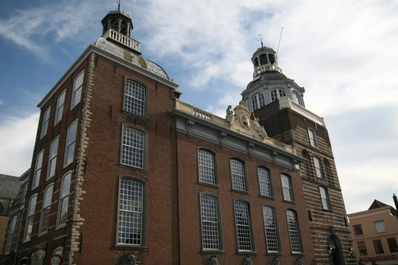 an old building with two towers against a blue sky