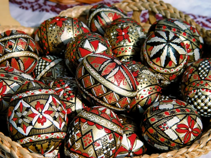 a basket filled with golden and red eggs