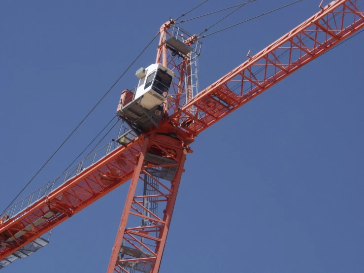 a train is coming down the tracks by the crane