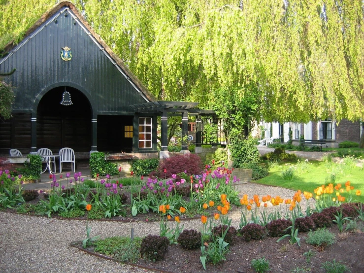 a flower garden near a house in the countryside