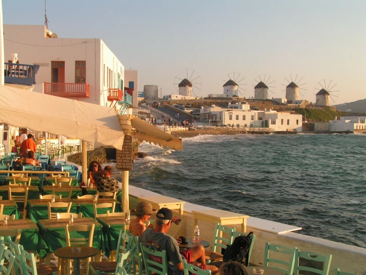 several people are eating outside at a table