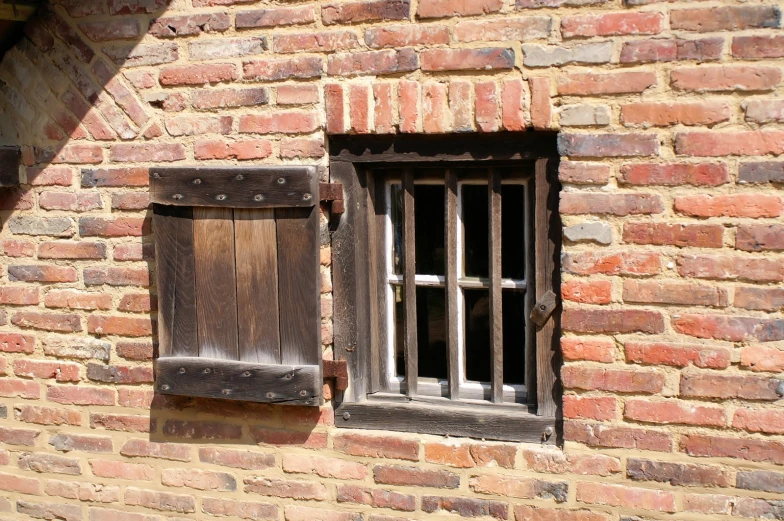 a close up of a brick building with an open window