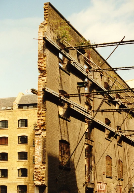 a dilapidated building is against a partly cloudy sky