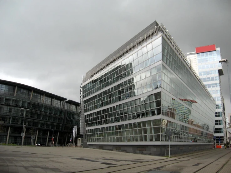 a very big tall glass building near some buildings