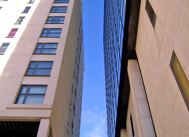 some very tall buildings in a city on a sunny day