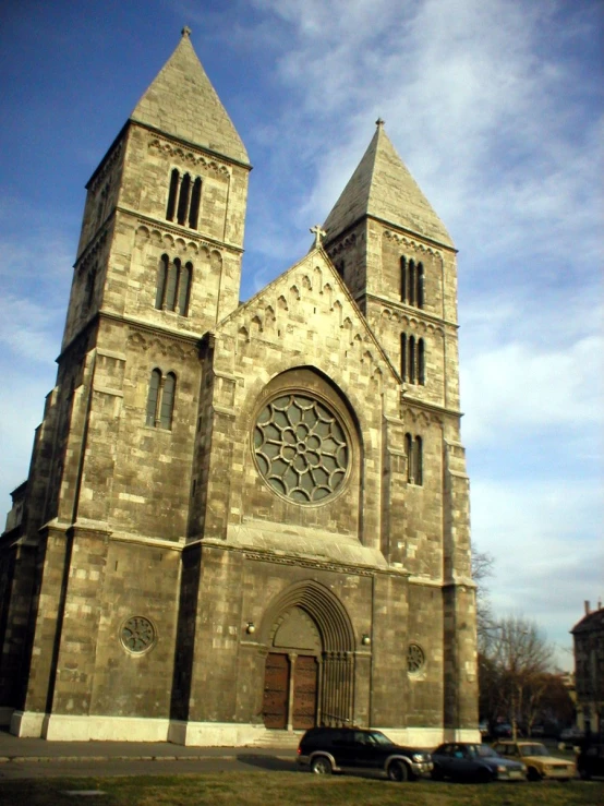 a large stone building with a stained glass window