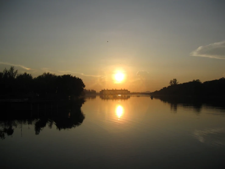 an image of a sunset setting over a river