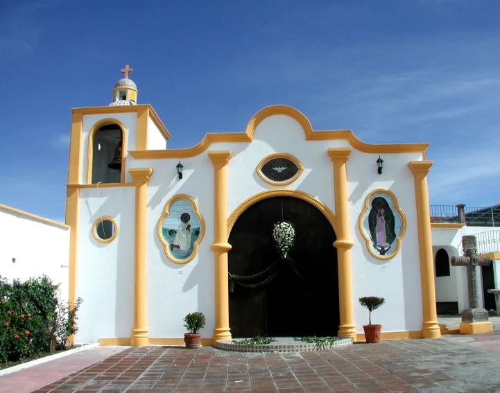 an entrance with three statues and large doors