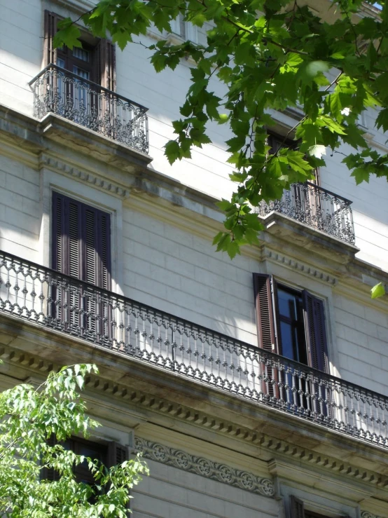 three balcony balconies on the side of a building