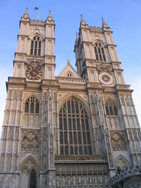 a tall cathedral with clocks on the front
