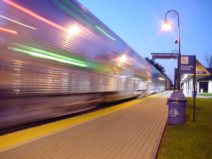 the blurred train is speeding down the track