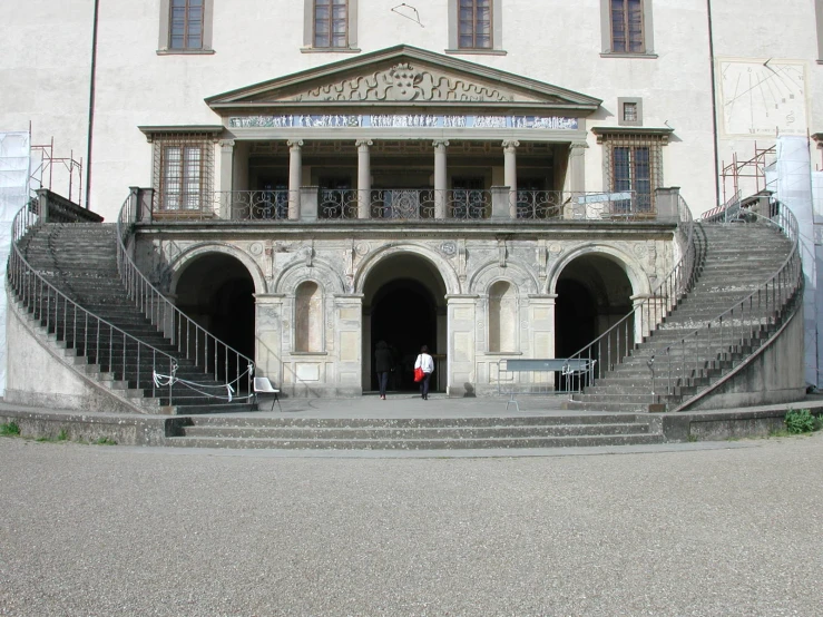 two people are standing in front of a building