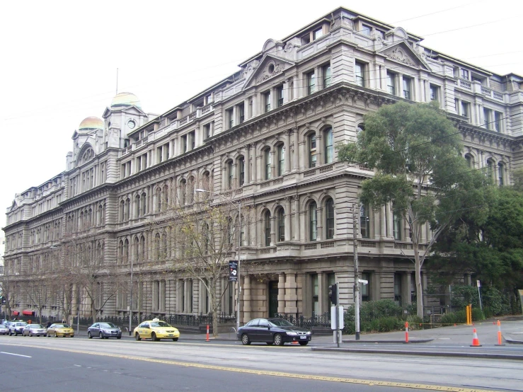 a big building on the corner of a busy street