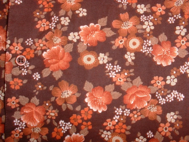 an image of red flowers on a brown cloth