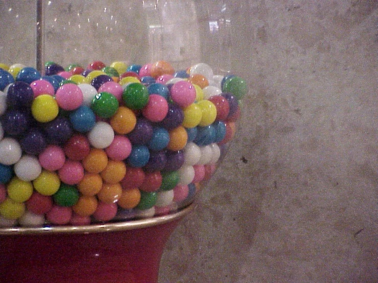 a large bucket filled with different colored balls