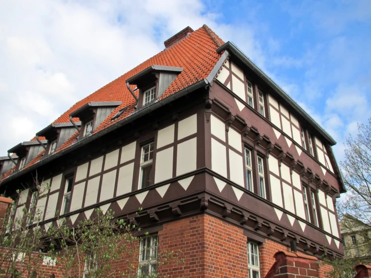 an old fashioned building is decorated with brown and white tiles