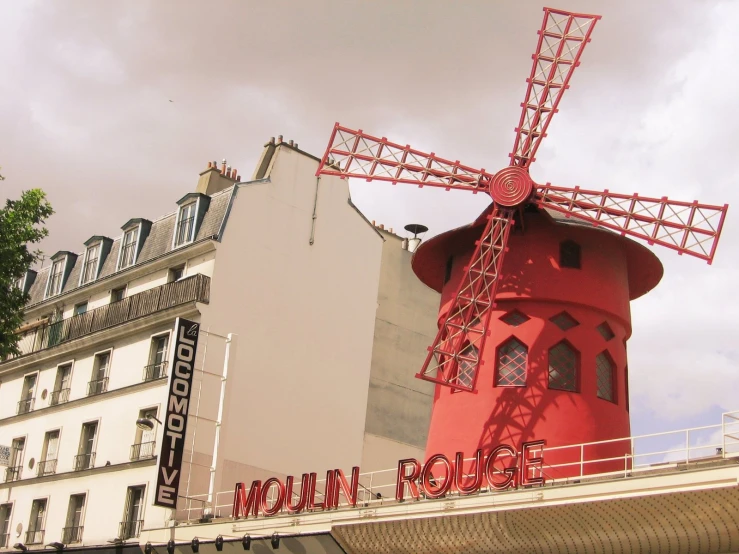 a red brick building with an old fashion windmill on top of it