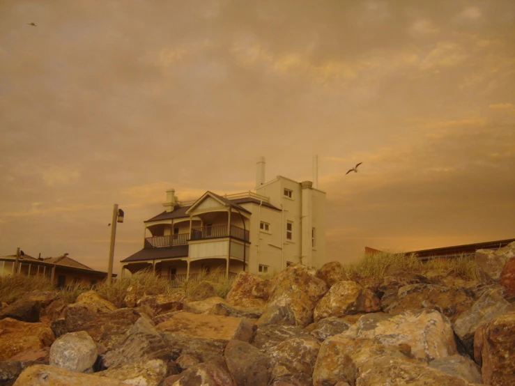 a white building on top of a hill with a sky background