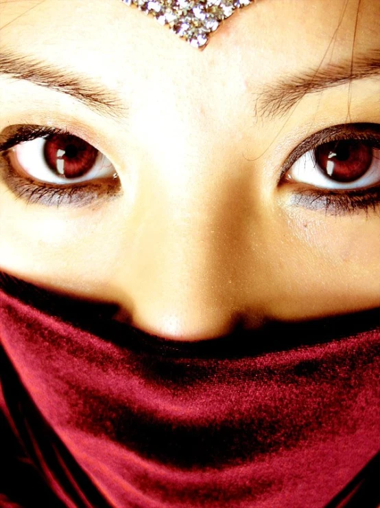 a woman in red scarf with large brown eyes