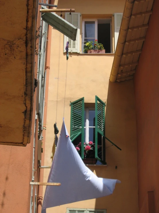 clothes hung out outside on a line by a building