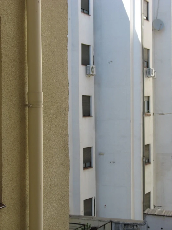 white buildings and one tall building with multiple windows