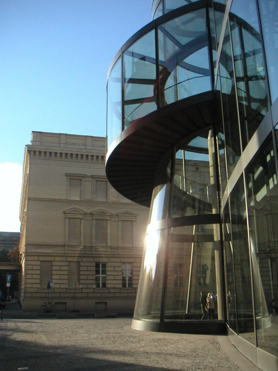 people are seen walking outside a large building