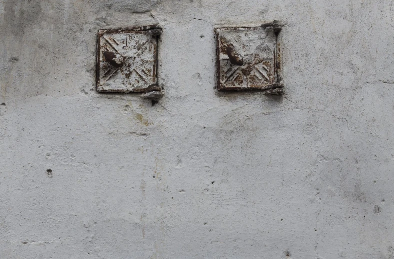 two cement blocks have metal details in them