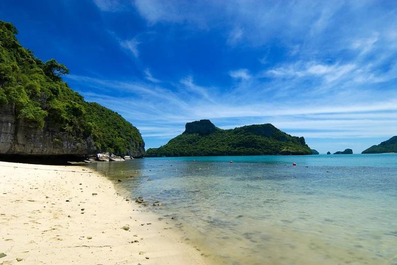 the blue sky, ocean and white sand beach on a tropical island