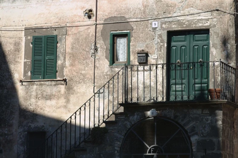 an old building with several green doors