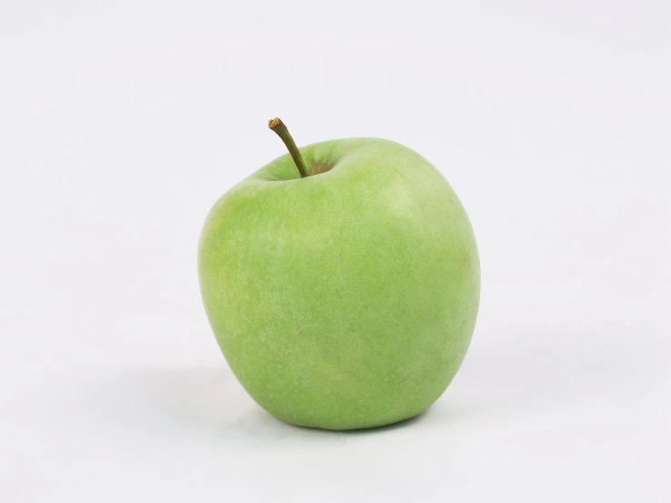 an apple is shown against a white backdrop