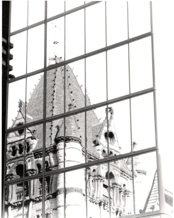 the reflection of a building in a glass wall