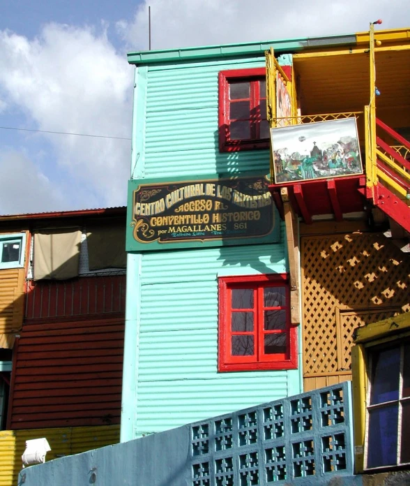 two small wooden buildings with colorful paint on the front
