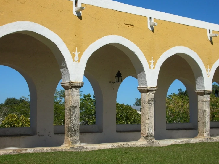 row of arches on concrete wall in outdoor setting