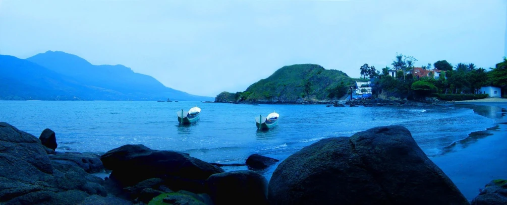 a couple of boats are sitting in the water