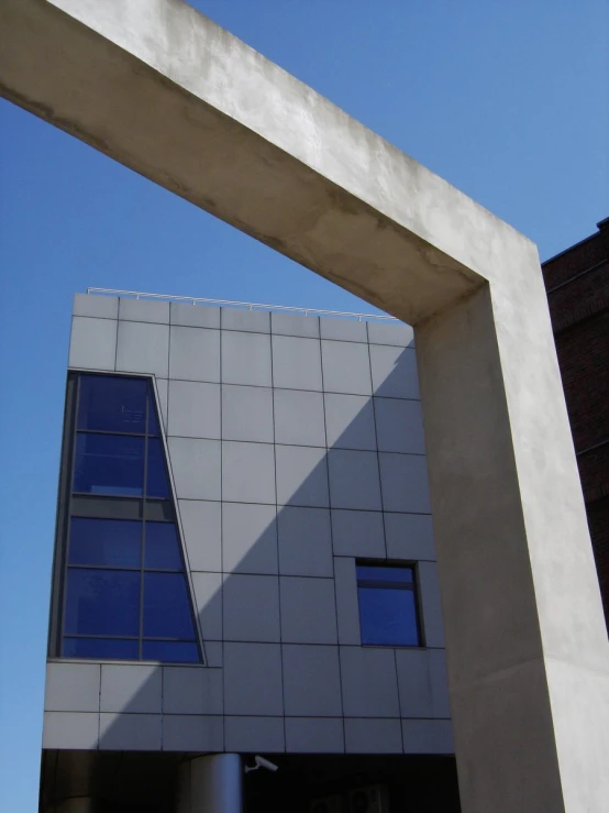 a large gray arch has two windows on it