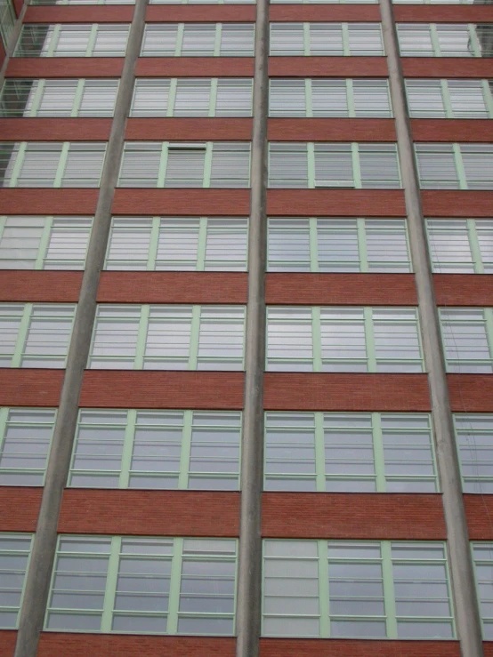 a large red brick building with windows and metal beams