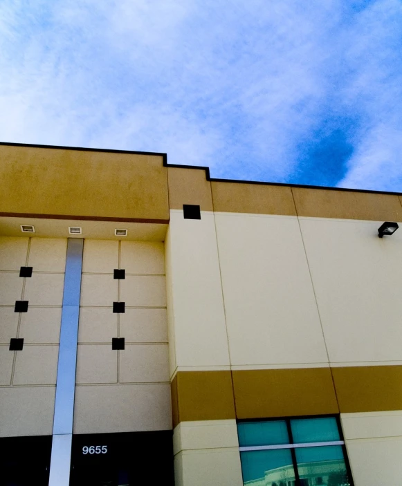 view from ground looking up of building with large windows